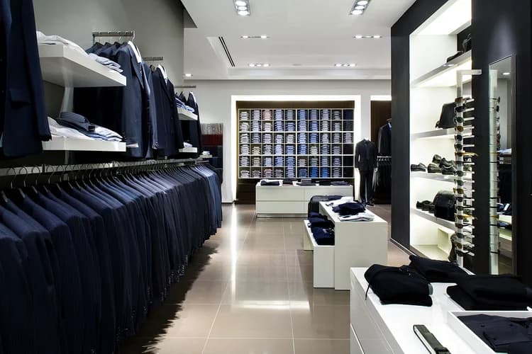 High-end retail boutique interior with shelving, folded apparel, and minimalist display